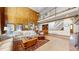 Elegant living room featuring high vaulted ceilings, wood paneling, and a view of the second floor at 6414 E Stanford Ave, Cherry Hills Village, CO 80111