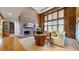 Bright living room with a brick fireplace, large windows, comfortable seating and wood accents at 6414 E Stanford Ave, Cherry Hills Village, CO 80111