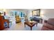 Cozy living room with bay window and chairs, features a vintage piano and decorative furniture at 6414 E Stanford Ave, Cherry Hills Village, CO 80111