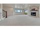 Expansive finished basement with stone fireplace, carpet, and large windows offering natural light at 1740 Joseph Cir, Elizabeth, CO 80107