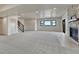 Large, open basement featuring carpet, stone fireplace, and natural light, great for entertaining at 1740 Joseph Cir, Elizabeth, CO 80107
