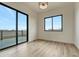 Bright bedroom with large windows and sliding doors leading to a balcony with scenic views at 1740 Joseph Cir, Elizabeth, CO 80107