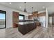 Modern kitchen with wood cabinets, stainless steel appliances, and a large center island with a countertop at 1740 Joseph Cir, Elizabeth, CO 80107