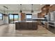 Bright kitchen featuring wood cabinets, stainless steel appliances, and large island under pendant lighting at 1740 Joseph Cir, Elizabeth, CO 80107