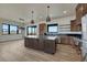 Bright kitchen with wood cabinets, stainless steel appliances, a center island, and sliding glass door at 1740 Joseph Cir, Elizabeth, CO 80107
