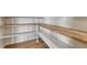 Spacious pantry featuring custom wood shelving for optimal organization and style at 1740 Joseph Cir, Elizabeth, CO 80107