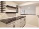Basement bar with dark countertops and wine rack at 2955 E Caley Ave, Centennial, CO 80121