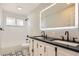 Modern bathroom features dual sinks, sleek vanity, and contemporary lighting at 2955 E Caley Ave, Centennial, CO 80121