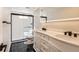 Modern bathroom with dual vanity, sleek black fixtures, and a stylish black-framed glass shower at 2955 E Caley Ave, Centennial, CO 80121