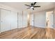 Bright bedroom features hardwood floors, a ceiling fan, and closet for ample storage at 2955 E Caley Ave, Centennial, CO 80121