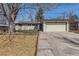 Ranch-style home with a two-car garage, manicured lawn, and a large tree in the front yard at 2955 E Caley Ave, Centennial, CO 80121