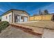 Detached garage with wooden accents, a gate, and pathway in the backyard at 2955 E Caley Ave, Centennial, CO 80121