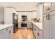 Well-equipped kitchen with stainless steel appliances, stylish cabinets, and a tiled backsplash at 2955 E Caley Ave, Centennial, CO 80121