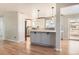 Modern kitchen with grey cabinets, quartz countertops, stainless steel appliances, and hardwood floors at 2955 E Caley Ave, Centennial, CO 80121