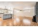 Open-concept living area featuring hardwood floors, a stone fireplace, and a modern kitchen island at 2955 E Caley Ave, Centennial, CO 80121