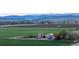 Stunning aerial view of farmland with barns, silos, and rolling hills in the background at 1805 W County Road 8, Berthoud, CO 80513