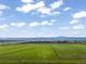 Expansive aerial view featuring open fields, clear skies, and distant mountains at 1805 W County Road 8, Berthoud, CO 80513
