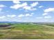 Expansive aerial view of green pastures on a sunny day with scenic mountain views in the distance at 1805 W County Road 8, Berthoud, CO 80513