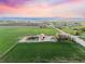 Breathtaking aerial shot of sprawling green farmland under a colorful sunset sky at 1805 W County Road 8, Berthoud, CO 80513