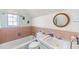 Charming bathroom with pink tile, a classic white tub, and a vintage mirror at 1805 W County Road 8, Berthoud, CO 80513