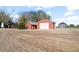 Multiple red outbuildings and silos offer ample storage and workspace on this expansive country property at 1805 W County Road 8, Berthoud, CO 80513