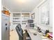 Bright home office with built-in display cabinets and a gray desk setup by the window at 1805 W County Road 8, Berthoud, CO 80513