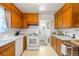 Classic kitchen with wood cabinets, white appliances, and a view of the exterior at 1805 W County Road 8, Berthoud, CO 80513