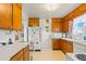 Charming kitchen featuring wooden cabinets and white appliances at 1805 W County Road 8, Berthoud, CO 80513