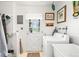 Functional laundry room with a vintage white washing machine and access to the outside at 1805 W County Road 8, Berthoud, CO 80513