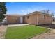 Brick home featuring a concrete patio and a freshly turfed area in the backyard at 12501 Randolph Pl, Denver, CO 80239