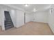 Spacious basement area with tile flooring, offering versatility for various uses at 12501 Randolph Pl, Denver, CO 80239