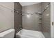 Well-lit bathroom showcasing a bathtub with modern tiled walls and built-in shelves at 12501 Randolph Pl, Denver, CO 80239