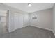 Cozy bedroom featuring neutral colors, a window, and a closet with bifold doors at 12501 Randolph Pl, Denver, CO 80239