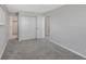 Cozy bedroom with plush gray carpet, neutral walls, and closet with sliding doors at 12501 Randolph Pl, Denver, CO 80239