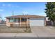 Charming brick home featuring an attached garage and a well-maintained front yard at 12501 Randolph Pl, Denver, CO 80239