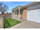 Inviting brick home with a covered entrance and a neatly manicured front lawn at 12501 Randolph Pl, Denver, CO 80239