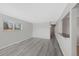 Spacious living area with sleek gray flooring and a view of adjacent rooms at 12501 Randolph Pl, Denver, CO 80239
