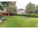 The spacious backyard features a lush lawn, garden, and wooden fence at 5473 W Prentice Ct, Littleton, CO 80123