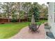 The manicured backyard features a patio, lush lawn, and beautiful landscaping at 5473 W Prentice Ct, Littleton, CO 80123