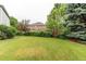Expansive backyard featuring a lush lawn and manicured hedges at 5473 W Prentice Ct, Littleton, CO 80123