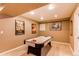 Basement recreation space with a carpeted floor and an air hockey table at 5473 W Prentice Ct, Littleton, CO 80123