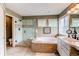 Bathroom with a glass enclosed shower, soaking tub, and vanity with sink at 5473 W Prentice Ct, Littleton, CO 80123