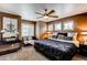 Bedroom with hardwood floor, a ceiling fan, table and lamps, and good natural light at 5473 W Prentice Ct, Littleton, CO 80123