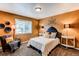 Cozy bedroom with a comfortable queen-size bed, window, chair and great natural light at 5473 W Prentice Ct, Littleton, CO 80123