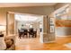 Elegant dining room with a beautifully set table, chandelier, and hardwood floors, perfect for entertaining guests at 5473 W Prentice Ct, Littleton, CO 80123