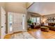 Inviting home entryway with gleaming hardwood floors and a cozy living room featuring plush seating and bright natural light at 5473 W Prentice Ct, Littleton, CO 80123
