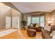 Inviting entryway with gleaming hardwood floors, an area rug, and a cozy living room with ample natural light at 5473 W Prentice Ct, Littleton, CO 80123