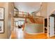 Stunning two-story foyer with hardwood floors, a curved staircase, and abundant natural light creating a grand entrance at 5473 W Prentice Ct, Littleton, CO 80123