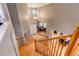 Elegant foyer with hardwood floors, graceful curved staircase, and abundant natural light from multiple windows at 5473 W Prentice Ct, Littleton, CO 80123