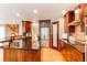 Well-lit kitchen with dark wood cabinets, stainless steel appliances, and an island at 5473 W Prentice Ct, Littleton, CO 80123